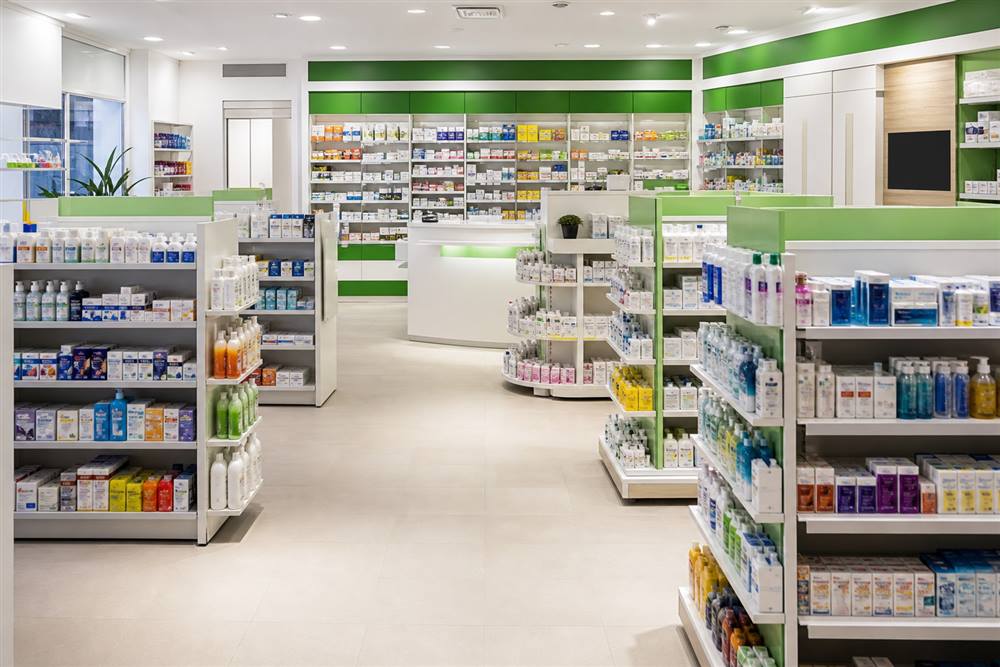Pharmacist helping a customer at the WellMed counter